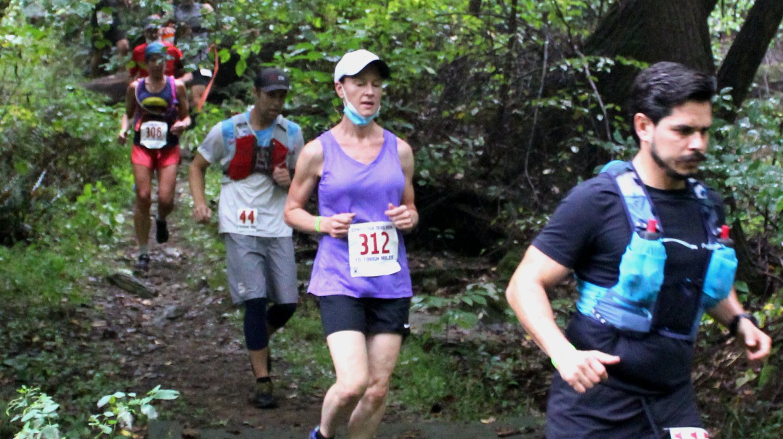 Photo of runners racing on trail
